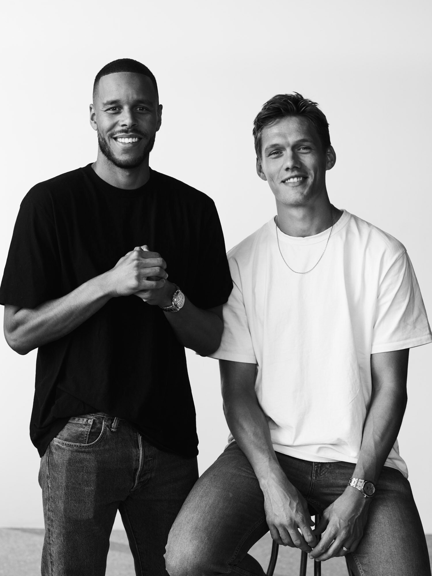 Mathias Zanka and Jannik Vestergaard pose together, smiling in a minimalist studio setting.
